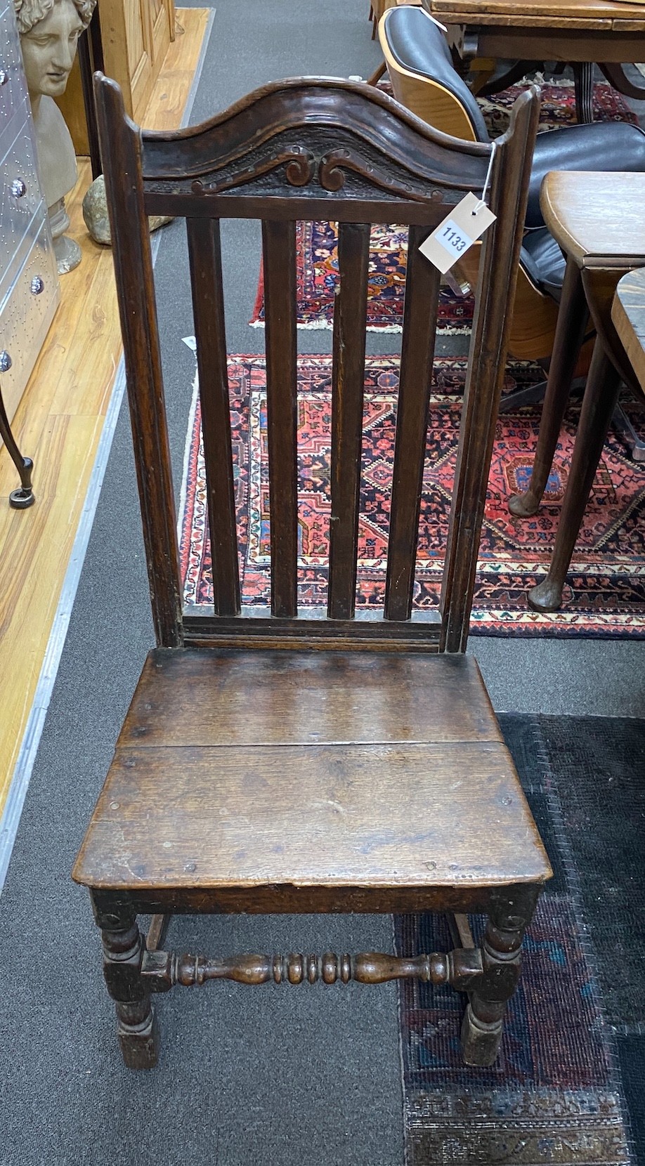 An early 18th century oak backstool dining chair